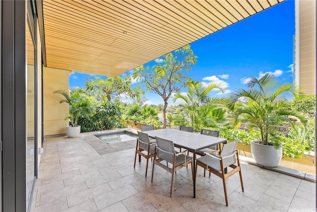 view of patio / terrace featuring outdoor dining area and a hot tub