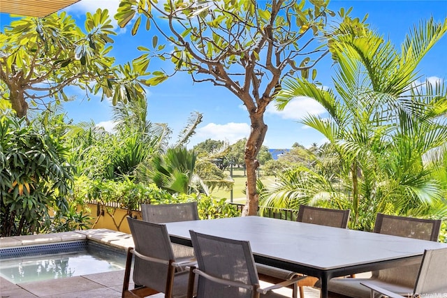 view of patio / terrace featuring a jacuzzi and outdoor dining space