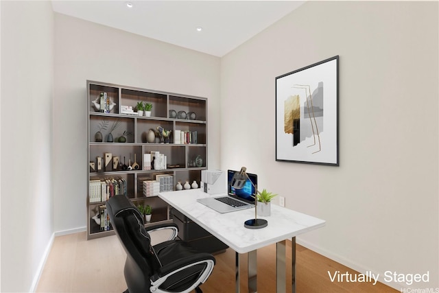 office space with baseboards and wood finished floors