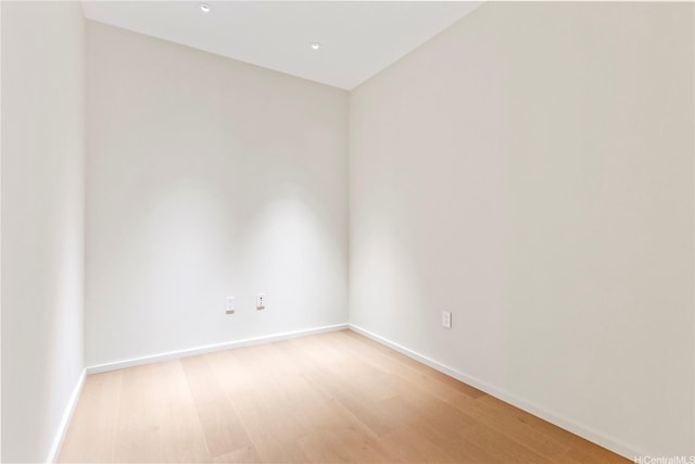 spare room with light wood-style floors and baseboards