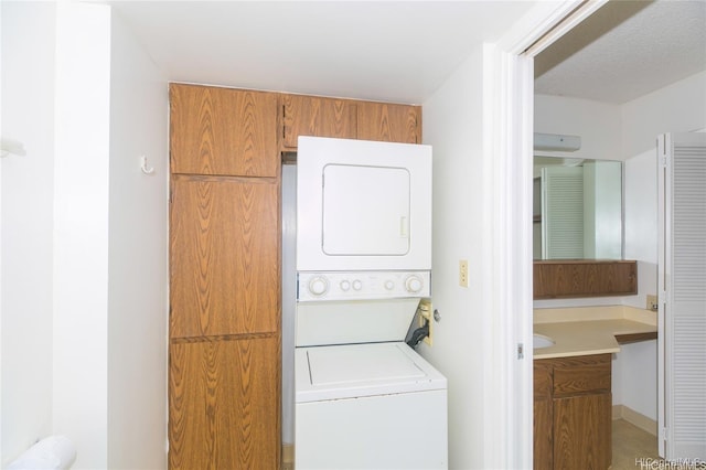 washroom with laundry area and stacked washer / dryer