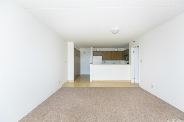 unfurnished living room featuring light colored carpet