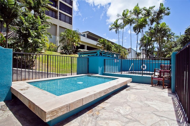 view of swimming pool with a yard and fence