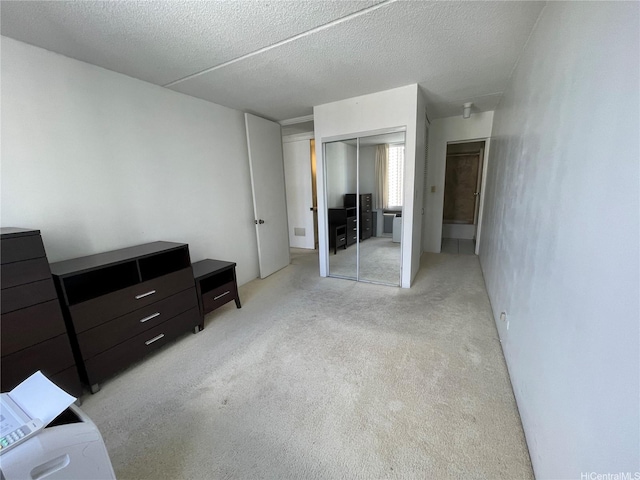 1717 Ala Wai Blvd Unit 2107, Honolulu, HI 96815 - bedroom featuring a closet, light carpet, and a textured ceiling