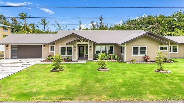 view of front of home with a garage, a front lawn, and driveway