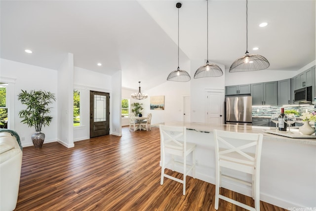kitchen with backsplash, stainless steel appliances, an inviting chandelier, and recessed lighting