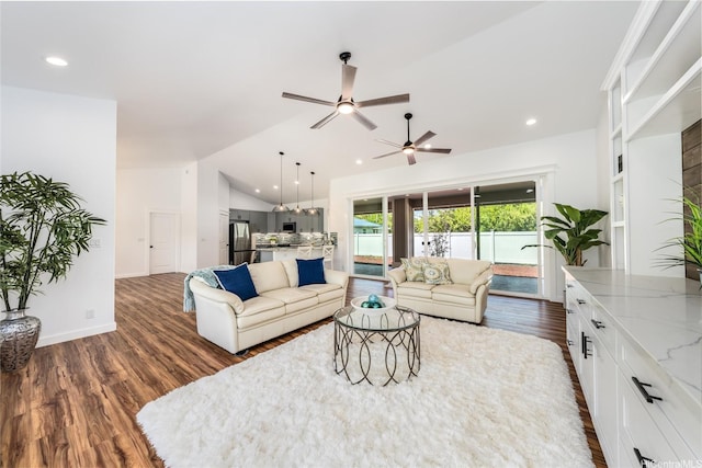 living area with dark wood-type flooring, a ceiling fan, lofted ceiling, and recessed lighting