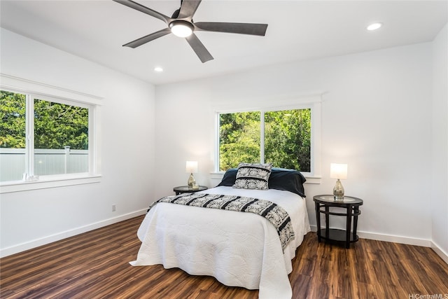 bedroom with baseboards, recessed lighting, wood finished floors, and multiple windows