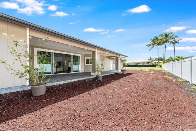back of property with a patio and fence