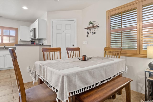 dining space featuring recessed lighting and light tile patterned floors