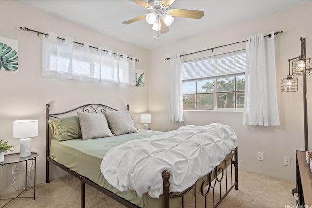 bedroom with multiple windows, a ceiling fan, and carpet flooring