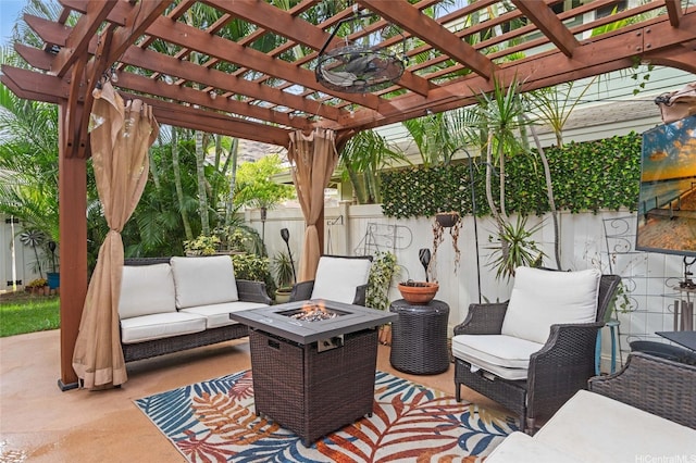 view of patio with an outdoor living space with a fire pit and fence