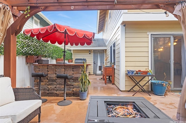 view of patio / terrace featuring an outdoor bar and an outdoor fire pit