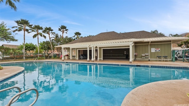 pool with fence and a patio