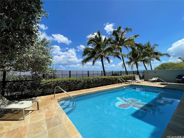 pool featuring fence and a patio area