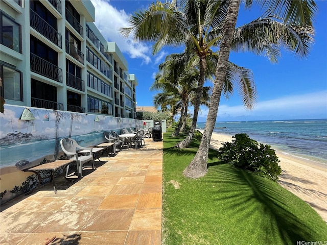 view of property's community featuring a beach view and a water view