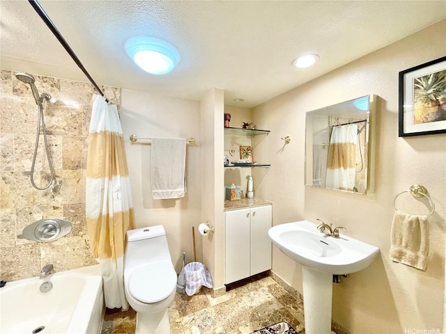 bathroom featuring shower / bath combo with shower curtain and toilet