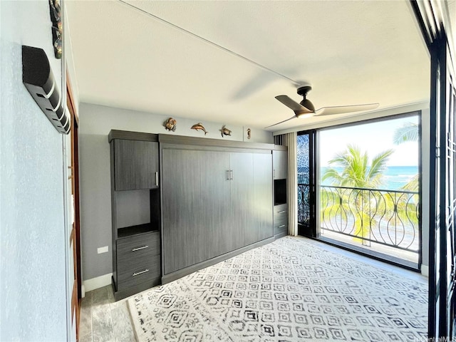 unfurnished bedroom with baseboards, access to exterior, and a closet