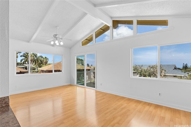 unfurnished room featuring ceiling fan, wood finished floors, and a wealth of natural light