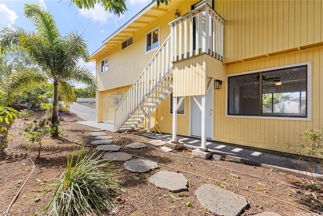 view of side of property featuring stairway