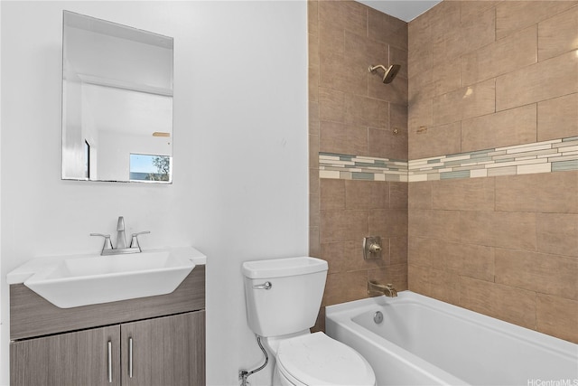 bathroom featuring toilet, shower / washtub combination, and vanity