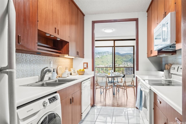 4340 Pahoa Ave Unit 19D, Honolulu, HI 96816 - kitchen featuring white appliances, washer / dryer, a sink, light countertops, and a textured ceiling