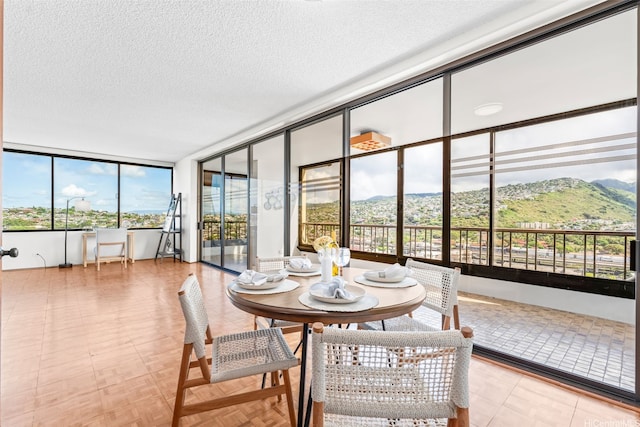 4340 Pahoa Ave Unit 19D, Honolulu, HI 96816 - dining room with plenty of natural light, a mountain view, and a textured ceiling