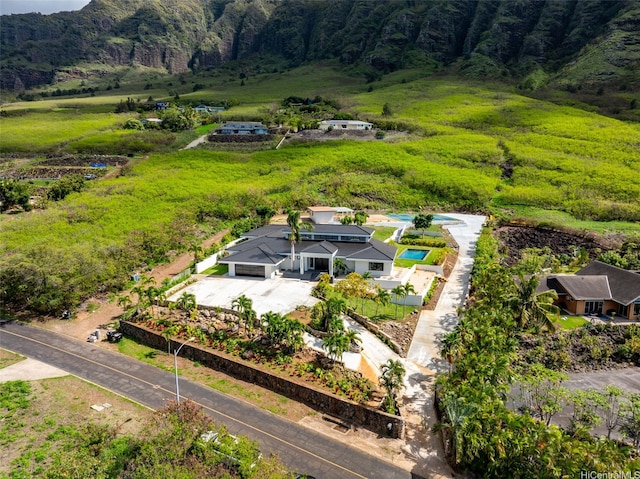 birds eye view of property featuring a wooded view and a mountain view