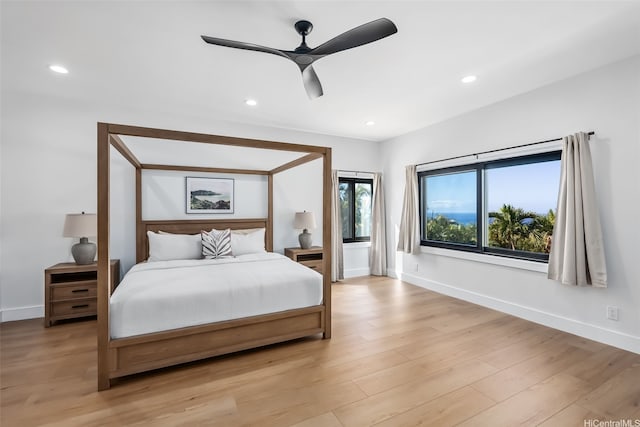 bedroom with baseboards, recessed lighting, and light wood-type flooring