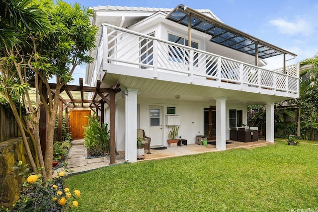 rear view of house with an outdoor hangout area, stucco siding, a yard, and a patio area