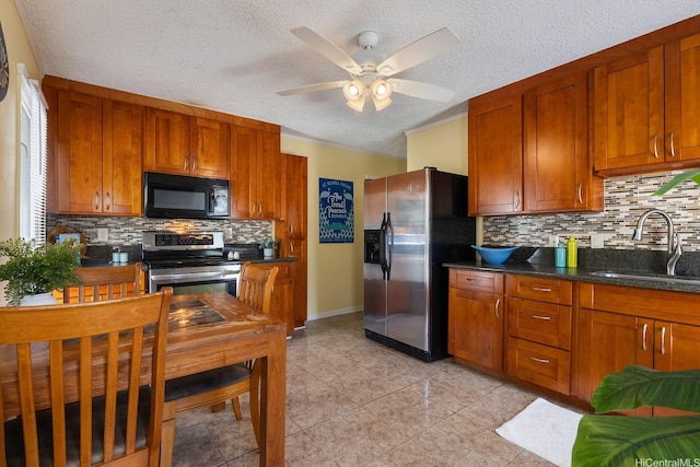 kitchen featuring decorative backsplash, ceiling fan, brown cabinets, a sink, and stainless steel appliances