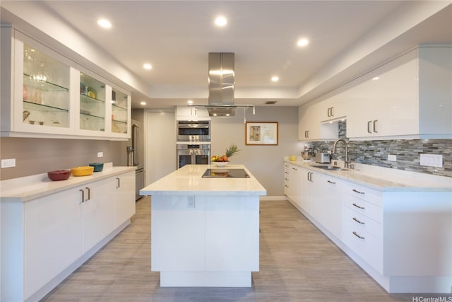 1022 Prospect St Unit 903E, Honolulu, HI 96822 - kitchen featuring island range hood, modern cabinets, a sink, white cabinets, and a center island