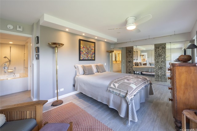 1022 Prospect St Unit 903E, Honolulu, HI 96822 - bedroom with wood finished floors, baseboards, recessed lighting, and connected bathroom