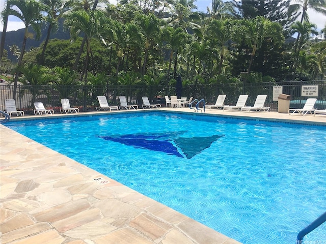 pool with fence and a patio