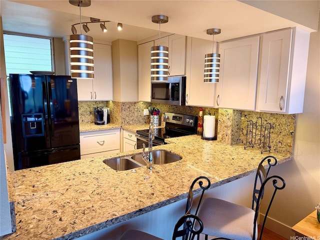 kitchen featuring a sink, light stone counters, tasteful backsplash, and stainless steel appliances