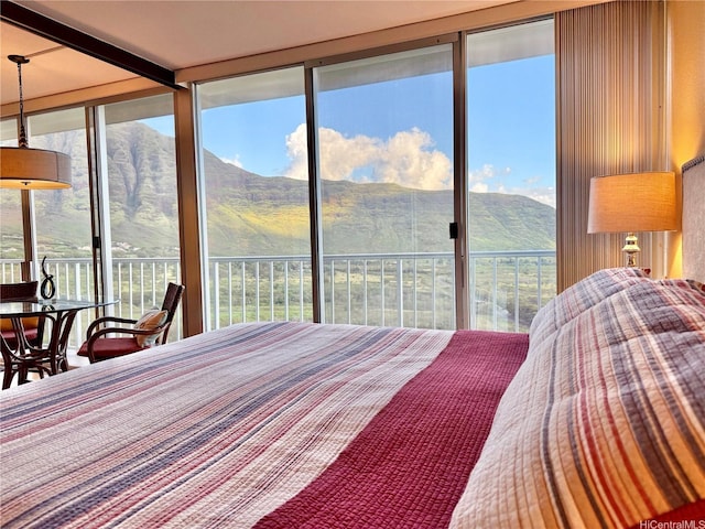 bedroom featuring a mountain view and access to exterior