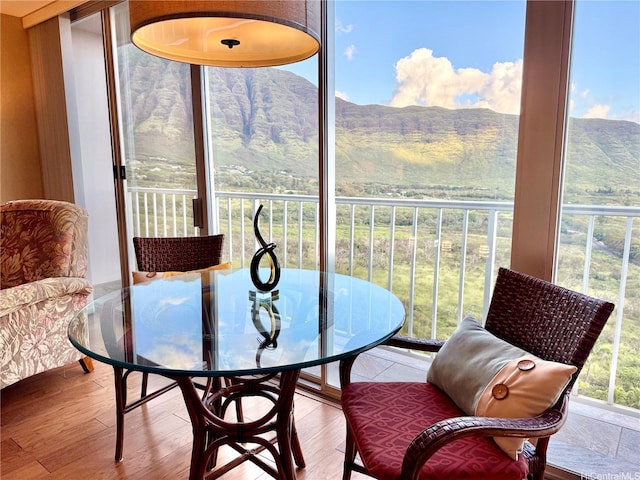 sunroom featuring a mountain view and wood finished floors