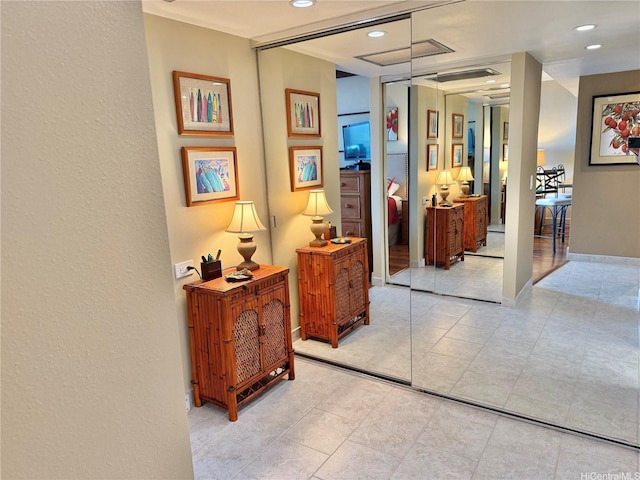 hallway featuring recessed lighting, visible vents, and light tile patterned flooring