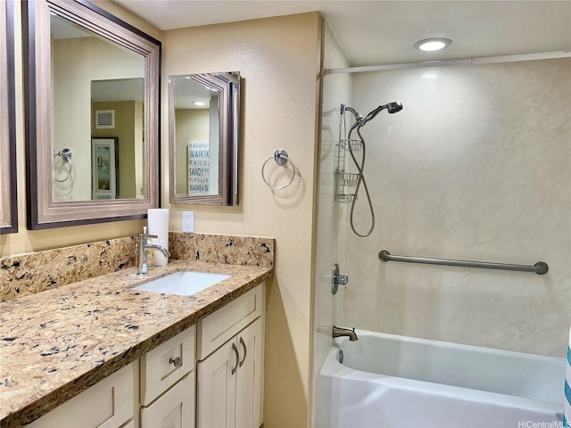 bathroom with vanity, bathtub / shower combination, and visible vents