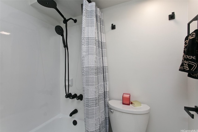 bathroom featuring shower / bath combination with curtain and toilet