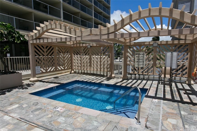 view of pool with a hot tub