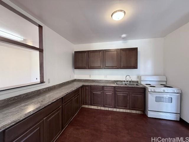 kitchen featuring white electric range, dark countertops, dark brown cabinets, and a sink