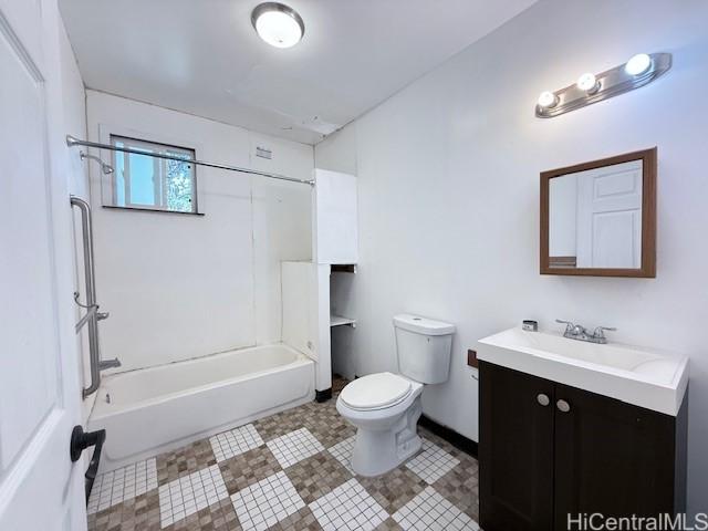 bathroom featuring vanity, toilet, and shower / bathtub combination