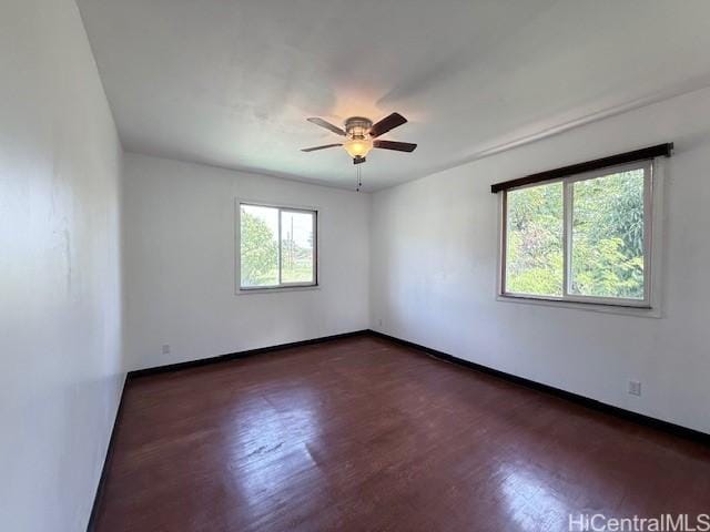unfurnished room with baseboards, ceiling fan, and wood finished floors