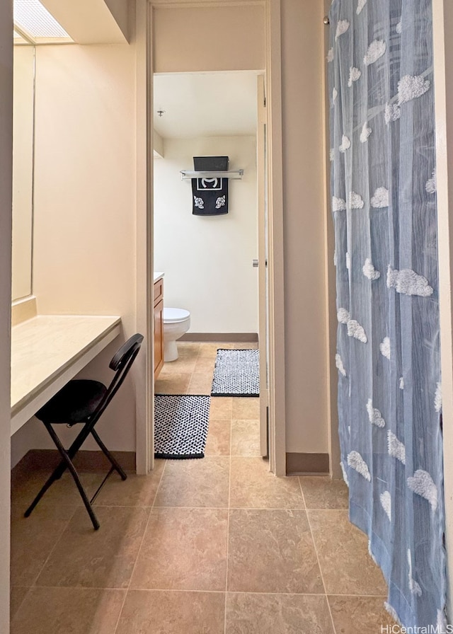 364 Seaside Ave Unit 1109, Honolulu, HI 96815 - bathroom featuring toilet, curtained shower, tile patterned floors, baseboards, and vanity