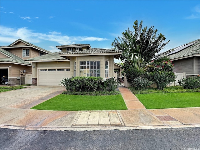 prairie-style home with a tiled roof, an attached garage, concrete driveway, and a front lawn