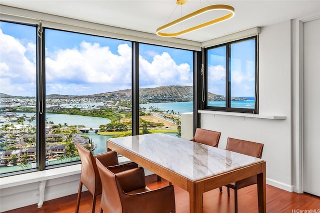 250 Kawaihae St Unit 18D, Honolulu, HI 96825 - dining space with plenty of natural light, a water view, and wood finished floors