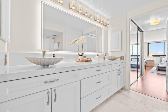 250 Kawaihae St Unit 18D, Honolulu, HI 96825 - ensuite bathroom featuring double vanity and marble look tiles