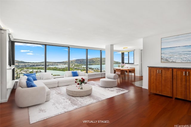 250 Kawaihae St Unit 18D, Honolulu, HI 96825 - living room featuring dark wood finished floors, floor to ceiling windows, and a water view