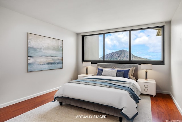 250 Kawaihae St Unit 18D, Honolulu, HI 96825 - bedroom with wood finished floors and baseboards